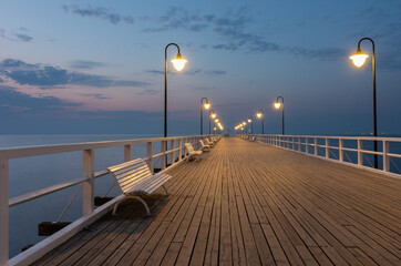 Baltic sea coast, night view of pier at Gdynia Orlowa sea resort, Poland.