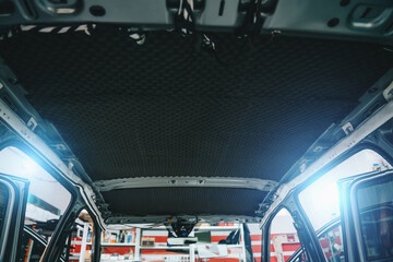 Obraz premium Car in process of installing sound insulation. Roof of car is covered from inside with soundproof material, auto tuning.