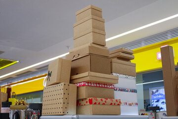 big pile a stack of cardboard holiday boxes and gift packages on display in a shopping mall