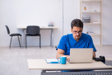 Young male doctor in telemedicine concept