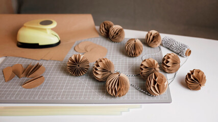 Craft Christmas paper decoration, tutorial. Making of festive garland with DIY honeycomb paper balls. Ecological and sustainable celebration. Seasonal activity with kids. Banner long format