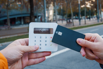 Woman making contactless payment on POS terminal