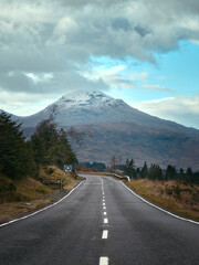 Mountain road stretching into the distance at autumn. Highlands, Scotland, United Kingdom