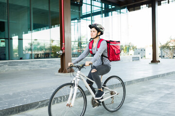 Beautiful delivery person on the bicycle