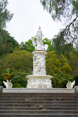 Fototapeta na wymiar Fountain The Fairytale with sculpture of woman and swans in Sochi Arboretum, Russia