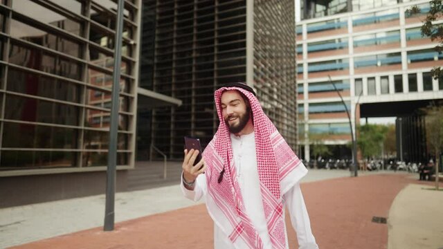 Arab man making video call on street
