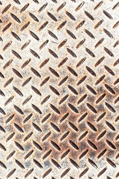 Metal plate background with a rusted zig zag design