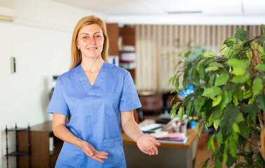 Positive female doctor posing in clinic
