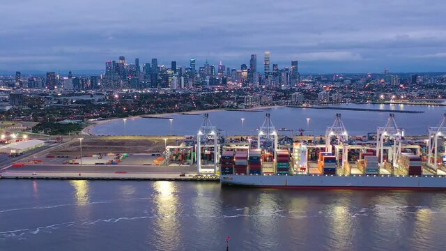 Aerial hyperlapse video of cargo terminal and Melbourne CBD at night