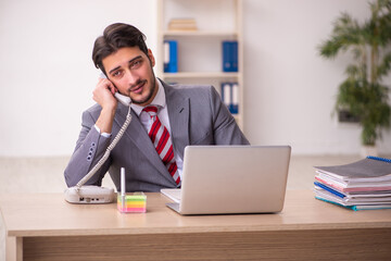 Fototapeta premium Young businessman employee working in the office