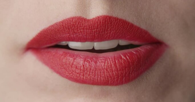 Woman Eating a Green Jelly Candy a Close up Shot of Red Lips and Nails
