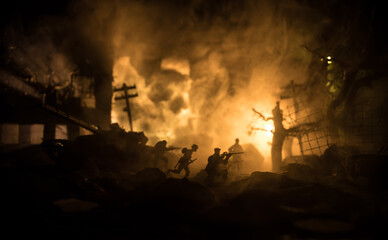 Fototapeta premium War Concept. Military silhouettes fighting scene on war fog sky background, World War Soldiers Silhouette Below Cloudy Skyline At night. Battle in ruined city.