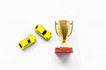 Golden trophy cup with car models. Rally champion winner concept