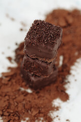 Dark Chocolate Petit Four Cakes Stack on Cocoa and Sprinkles Vertical, Valentine's Day Dessert