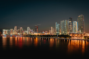 Fototapeta na wymiar city skyline at night Miami Florida reflections buildings downtown water sea lights 