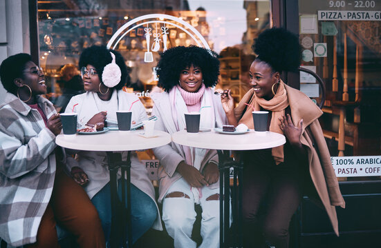 Happy African American Friends Sitting in Street Cafe on Winter Holidays
