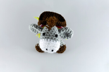 Small-eared donkey with its brown saddlebag. Crochet stuffed animal