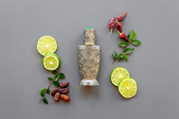 Silver bottle of arabian oud perfume with ingredients