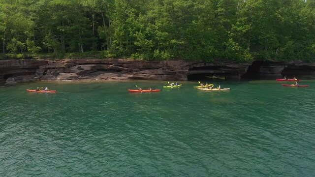Group of kayakers exploring an amazing landscape at Madeline island Big bay state park in Wisconsin, Lake Superior Apostles island