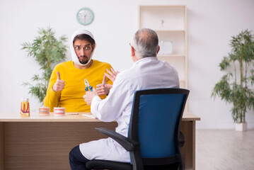 Young man visiting experienced male dentist