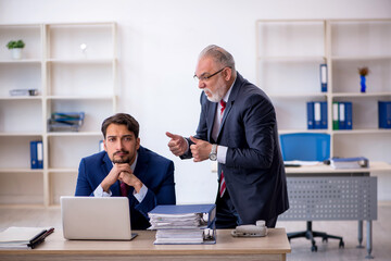 Two male colleagues working in the office