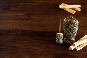 Agar wood tree oil perfume in silver bottle with sticks of tree