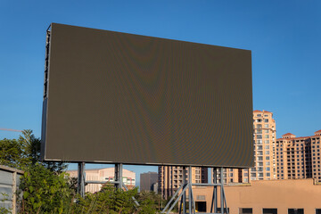 A large LED screen with blue sky background