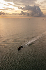 sunset on the sea horizon while as ships passed on the sea