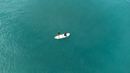 Unidentified two men on sea Kayaker Aerial View during sunset. Caucasian Sportsman in the Yellow...