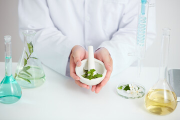Plants and flowers extract in petri dish and a white background in laboratory , green leaf  in a test tube and doctor for cosmetic advertising , photography science concept