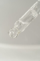 Pipette with bubbles on a white background.