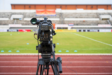 Video camera before live video streaming at the soccer green glass field background.Camera for cameraman recording at media press corner. Live streaming concept.