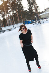 figure skater on ice. the girl is skating. ice under the open sky. No makeup in winter, red cheeks
