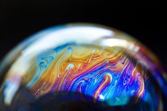 Abstract pattern, multicolored chaotic texture inside of the soap bubble, closeup