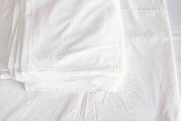 White comfort bed and soft pillow in bedroom. White blanket in hotel bedroom. Copy space