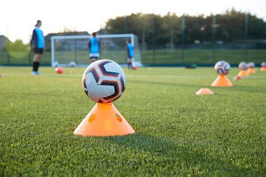 UK, Soccer balls on cones in field