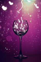 Bright lights in a wine glass, made of transparent glass. The movement of the glowing bulbs in the glass. Interesting, bright, festive background, for Christmas and New year.