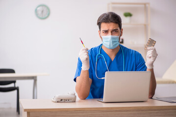 Young male doctor in vaccination concept during pandemic