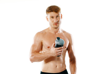 a man an athlete with a pumped-up body drinks from a bottle