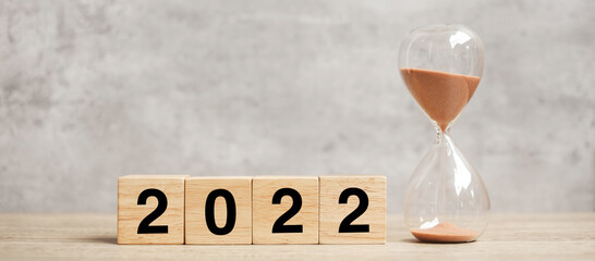 2022 text with hourglass on table. Resolution, time, plan, goal, motivation, reboot, countdown  and...