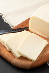 Fresh mozzarella cheese on cutting board.