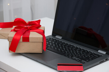 Laptop, gift box and credit card. Christmas online shopping concept.
