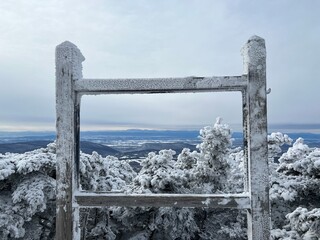 snow covered wood frame with view of mountains