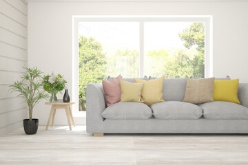 White living room with sofa and summer landscape in window. Scandinavian interior design. 3D illustration