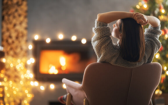 woman is relaxing near Christmas tree
