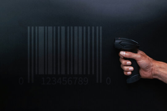 Barcode concept. Retail label barcode scan. Reader laser scanner for warehouse on black background. Warehouse inventory management.