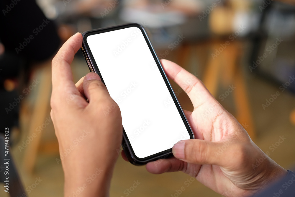 Poster close up view of man hands holding smart phone with empty display.