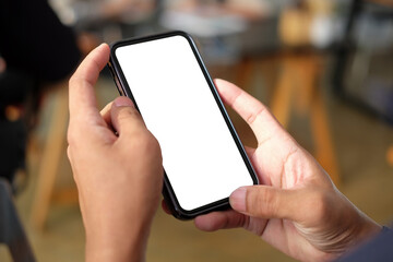 Close up view of man hands holding smart phone with empty display.