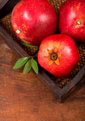 Ripe pomegranate fruits on the wooden background