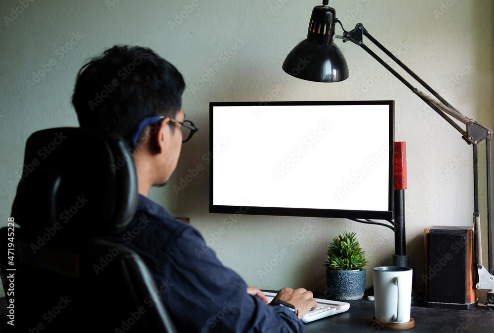 Poster Rear view businessman working with computer while sitting in modern workplace..